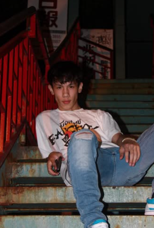 Ethan Yau, a young man with a headset on, gaming at his computer.